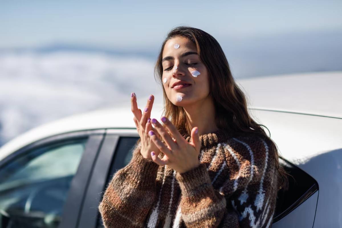 A woman in a cozy brown sweater gestures with her hands
